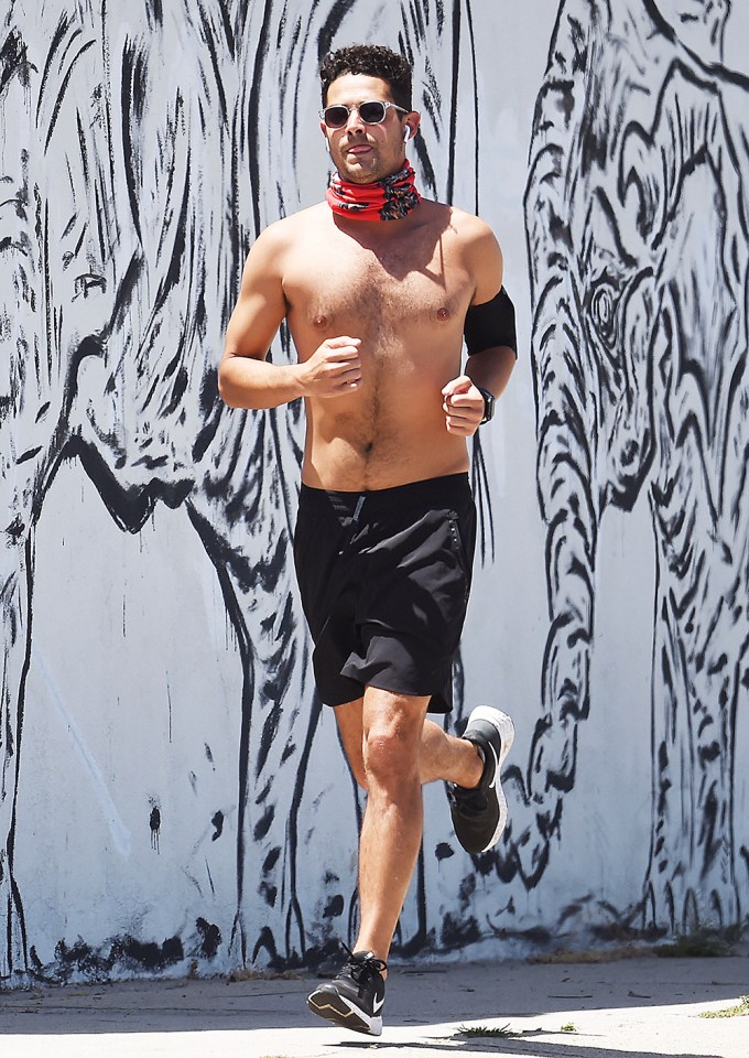 Wells Adams goes jogging shirtless with a red bandana tied around his neck