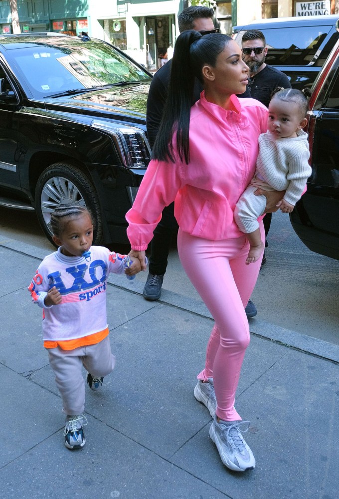 Kim Kardashian holds Saint’s hand and carries Chicago