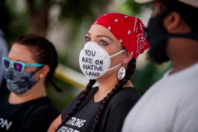 A protester makes a statement on a face mask