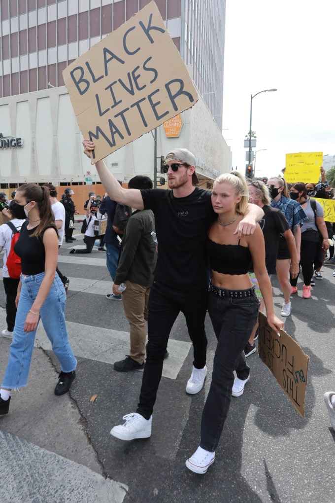 Logan Paul & Josie Canseco walking as part of a protest