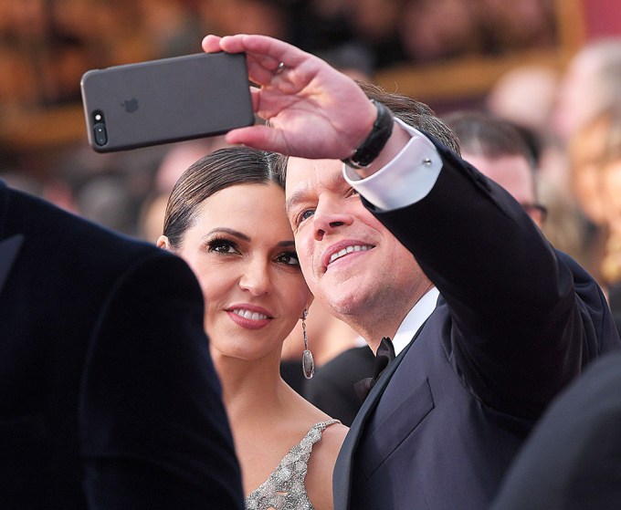 Matt Damon and Luciana Barroso take a selfie at the Oscars