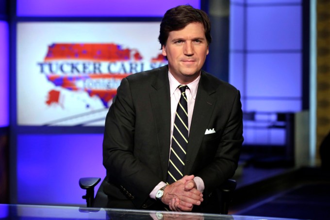 Tucker Carlson poses on set of Fox News in 2017.