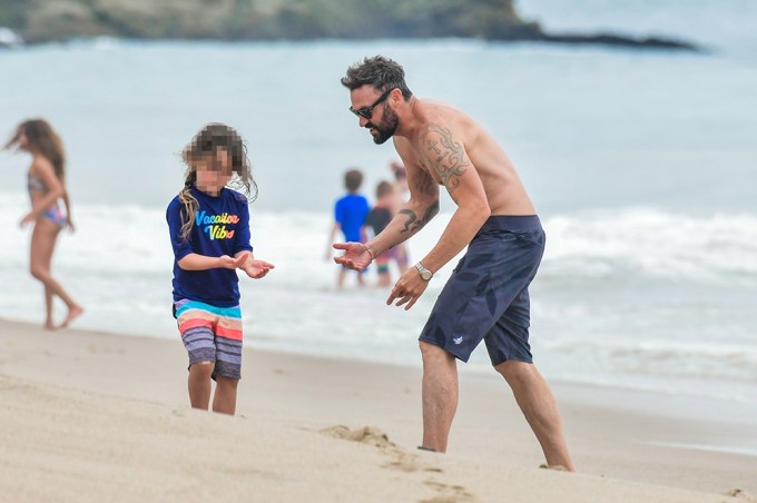 Brian Austin Green plays with his son at the beach