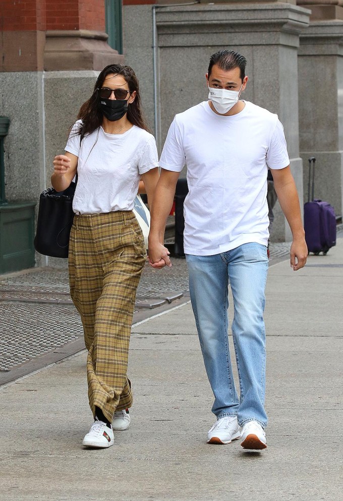 Katie Holmes and Emilio Vitolo Jr. hold hands walking to the subway.