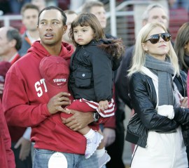 FILE - This Nov. 21, 2009, file photo shows Tiger Woods, daughter Sam Woods,  and wife Elin Nordegren, before an NCAA college football game in Stanford, Calif. Golf's biggest star on Friday, Feb. 19, 2010, will address the shocking and sordid sex scandal that has consumed his life since late November then will return to the clinic where he has been undergoing therapy, according to a letter from PGA Tour commissioner Tim Finchem obtained by The Associated Press. (AP Photo/Marcio Jose Sanchez, File)