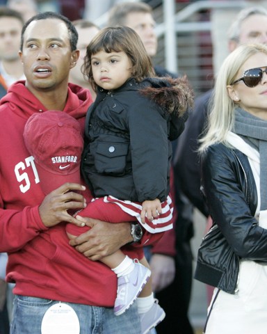 FILE - This Nov. 21, 2009, file photo shows Tiger Woods, daughter Sam Woods,  and wife Elin Nordegren, before an NCAA college football game in Stanford, Calif. Golf's biggest star on Friday, Feb. 19, 2010, will address the shocking and sordid sex scandal that has consumed his life since late November then will return to the clinic where he has been undergoing therapy, according to a letter from PGA Tour commissioner Tim Finchem obtained by The Associated Press. (AP Photo/Marcio Jose Sanchez, File)