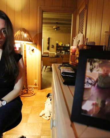 In this Feb. 13, 2017 photo, Casey Anthony poses for a portrait next to a photo of her daughter, Caylee, in her West Palm Beach, Fla., bedroom. In an exclusive interview with The Associated Press, Anthony claims the last time she saw Caylee she “believed that she was alive and that she was going to be OK.” (AP Photo/Joshua Replogle)