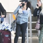 *EXCLUSIVE* Christina Milian wears a protective mask while arriving at Paris-Charles De Gaulle airport with her son Isaiah!