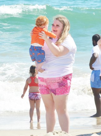 EXCLUSIVE: Honey Boo Boo and her family are seen enjoying a day at the beach in LA. The reality TV star, 16, has been on vacation in the city and took a trip to the ocean in Santa Monica, CA. Honey Boo Boo, real name Alana Thompson, was joined by her older boyfriend Dralin Carswell, 20, and the pair were seen playing on the sand. Also present was Lauryn ‘Pumpkin’ Efird who brought her newborn twins Sylus and Stella to the shoreline along with her other children Ella, four, and Bentley, 11 months. Alana wore a cute pair of pink shorts and a white T-shirt and was seen laughing as she held little Bentley. 06 Jul 2022 Pictured: Honey Boo Boo and Pumpkin cool off in the ocean while taking refuge from the sweltering heat in L.A. with Josh, Dralin and Pumpkin's newborn twins at Santa Monica Beach in Los Angeles. Photo credit: Garrett Press/MEGA TheMegaAgency.com +1 888 505 6342 (Mega Agency TagID: MEGA875497_005.jpg) [Photo via Mega Agency]