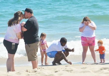 EXCLUSIVE: Honey Boo Boo and her family are seen enjoying a day at the beach in LA. The reality TV star, 16, has been on vacation in the city and took a trip to the ocean in Santa Monica, CA. Honey Boo Boo, real name Alana Thompson, was joined by her older boyfriend Dralin Carswell, 20, and the pair were seen playing on the sand. Also present was Lauryn ‘Pumpkin’ Efird who brought her newborn twins Sylus and Stella to the shoreline along with her other children Ella, four, and Bentley, 11 months. Alana wore a cute pair of pink shorts and a white T-shirt and was seen laughing as she held little Bentley. 06 Jul 2022 Pictured: Honey Boo Boo and Pumpkin cool off in the ocean while taking refuge from the sweltering heat in L.A. with Josh, Dralin and Pumpkin's newborn twins at Santa Monica Beach in Los Angeles. Photo credit: Garrett Press/MEGA TheMegaAgency.com +1 888 505 6342 (Mega Agency TagID: MEGA875497_018.jpg) [Photo via Mega Agency]