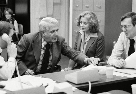 Barbara Walters, right, television's first woman to anchor a news program, talks with Harry Reasoner in the ABC network newsroom as she prepares for her debut on the evening news in New York.  Barbara Walters will co-anchor the show with Harry Reasoner Barbara Walters and Harry Reasoner, New York, USA