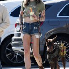 EXCLUSIVE: Paris Jackson shows off her legs and midriff in a pair of denim cut-off short shorts and an Iggy Pop T-shirt with her Doberman Pincher stepping out for the first time since posing in a nude dress