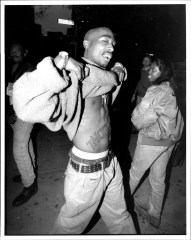 Tupac Shakur flashed his belly tattoo which reads, "THUG LIFE" as he leaves court in New York City where he faces charges of sexual assault. **NO NEW YORK DAILY NEWS, NO NEW YORK TIMES, NO NEWSDAY**. 09 Nov 1994 Pictured: Tupac Shakur. Photo credit: David Rentas / NY Post / MEGA TheMegaAgency.com +1 888 505 6342 (Mega Agency TagID: MEGA681316_001.jpg) [Photo via Mega Agency]