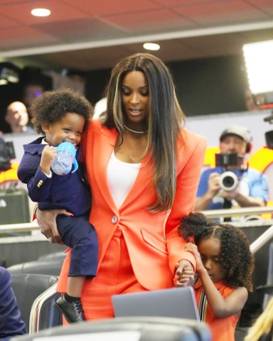 Rap stsr Ciara, cneter, wife of Denver Broncos new starting quarterback Russell Wilson, carries the couple's son, Win. left, while leading daughter Sienna into a news conference, at the team's headquarters in Englewood, Colo Broncos Wilson Football, Englewood, United States - 16 Mar 2022
