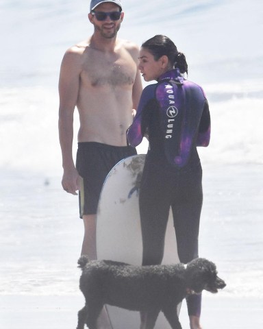 EXCLUSIVE: Ashton Kutcher and Mila Kunis spend Labor Day weekend at the beach cooling off from the sweltering heat wave in Santa Barbara on Sunday. Ashton used a surf board and a body board to catch waves while Mila did a little boogie boarding and body surfing. Mila used a wetsuit while she caught waves. Ashton recently revealed he suffered from Vasculitis a couple years ago and said he had a difficult time recovering but is okay now. He recently revealed a significant weight loss as well. 04 Sep 2022 Pictured: Ashton and Mila go surfing. Photo credit: Garrett Press/MEGA TheMegaAgency.com +1 888 505 6342 (Mega Agency TagID: MEGA892118_047.jpg) [Photo via Mega Agency]
