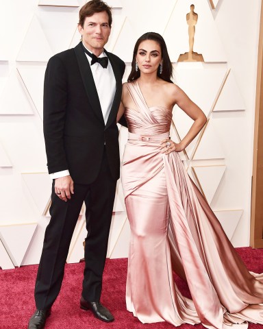 Ashton Kutcher, left, and Mila Kunis arrive at the Oscars, at the Dolby Theatre in Los Angeles 94th Academy Awards - Arrivals, Los Angeles, United States - 27 Mar 2022