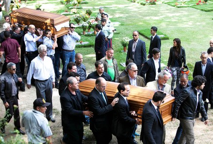 Relatives and friends carry the remains of Monica Spear, right, and of her ex-husband Thomas Henry Berry, top left, during their funeral at the East Cemetery in Caracas, Venezuela, . Robbers killed actress Spear, 29, and her former husband Berry, 39, late Monday night on an isolated stretch of highway while the couple was returning to the capital by car with their 5-year-old daughter from a vacation
Venezuela Slain Actress, Caracas, Venezuela