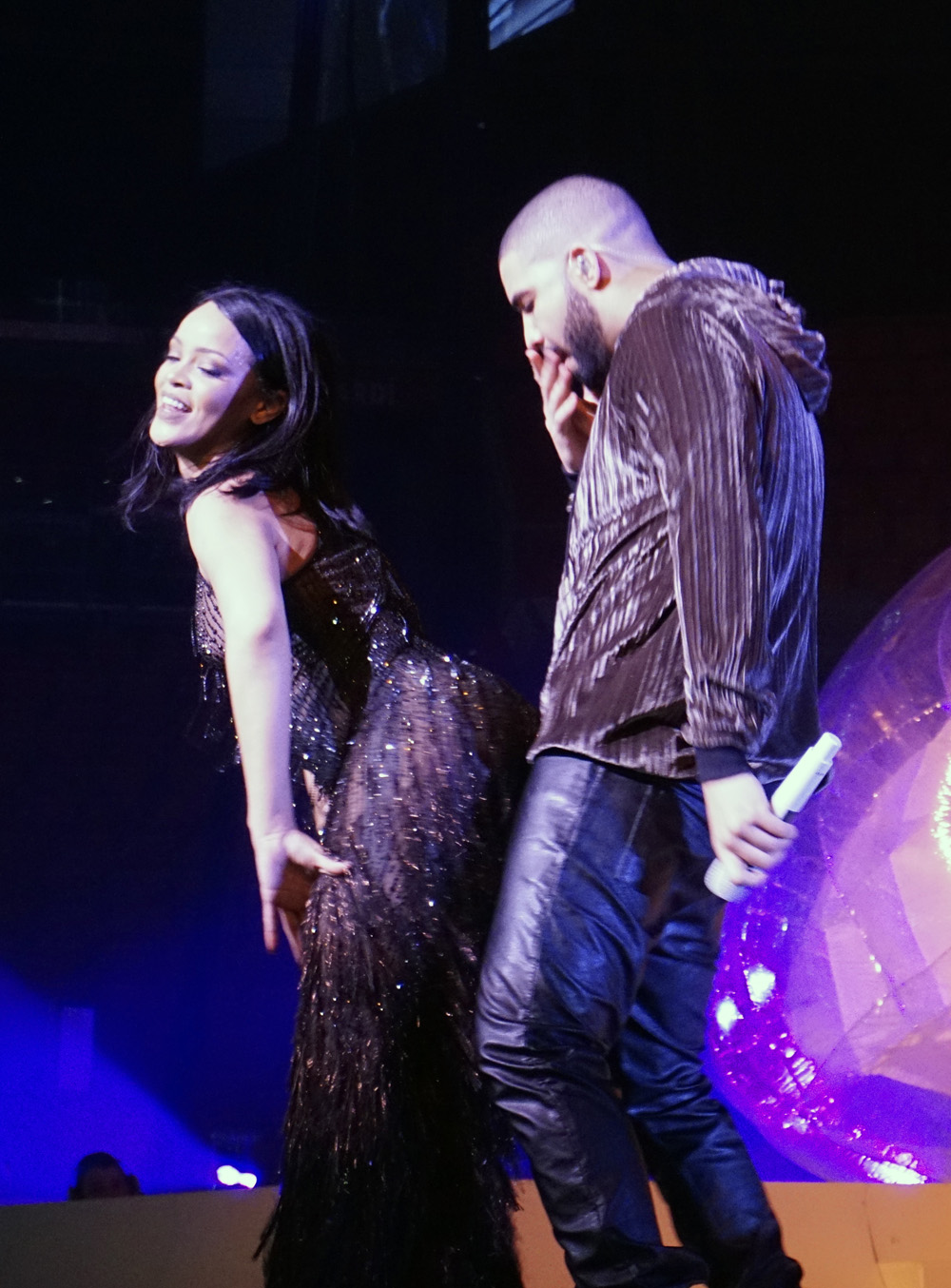 Rihanna goes braless in a sheer bodysuit as she twerks on stage with Drake during a performance of their hit single "Work" as part of the Anti World Tour in Miami