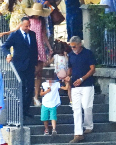 CERNOBBIO, ITALY - *EXCLUSIVE* - Actor George Clooney and his wife Amal enjoy their family holidays in the province of Como.The 61-year-old The Ocean's Eleven actor looked casual in his blue top during a boat ride with Amal who was stunned in her summer dress and hat, taking in the sights of their picturesque surroundings during the family trip.Pictured: George Clooney - Amal Clooney BACKGRID USA 13 JULY 2022 BYLINE MUST READ: COBRA TEAM / BACKGRIDUSA: +1 310 798 9111 / usasales@backgrid.comUK: +44 208 344 2007 / uksales@backgrid.com*UK Clients - Pictures Containing ChildrenPlease Pixelate Face Prior To Publication*
