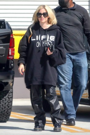 Los Angeles, CA  - *EXCLUSIVE*  - Engaged ? Avril Lavigne displays what appears to be a very large engagement ring while arriving at a studio in Los Angeles on Tuesday. Avril wasn't wearing the large diamond as she attended the Grammys over the weekend, could the Canadian singer-songwriter be engaged to her singer beau Mod Sun?Avril and Mod Sun (real name: Derek Smith) from coworkers to romance.In January 2021 the couple cowrote the single "Flames" and appeared in a music video for the song together. Mod Sun marked his love with Avril's name tattooed on his neck in February 2021. The made their first red carpet debut at the 2021 MTV Video Music Awards. They shared more of their love on instagram posting PDA photos for fans to go wild over. March of 2022 Avril appeared on Kelly Clarkson all giddy and talking about her connection with Mod Sun. Kelly Clarkson Show March 2022"I went into the studio and literally was like, 'Here is where I am at. I am over love. I'm jaded on love right now,'" she shared in March 2022. "So I wrote that song 'Love Sux' and that set the tone for this album. And then a couple of days later, I had a boyfriend. I'm literally never single." *Shot on April 5, 2022**Pictured: Avril LavigneBACKGRID USA 6 APRIL 2022 BYLINE MUST READ: BENS / BACKGRIDUSA: +1 310 798 9111 / usasales@backgrid.comUK: +44 208 344 2007 / uksales@backgrid.com*UK Clients - Pictures Containing ChildrenPlease Pixelate Face Prior To Publication*
