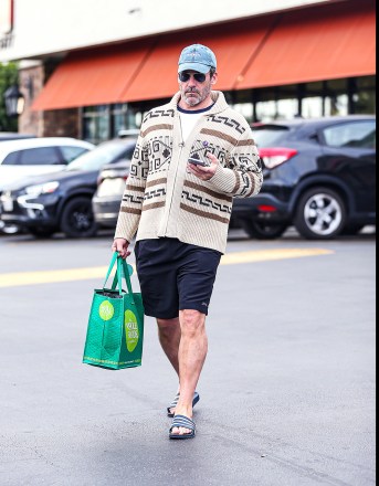 EXCLUSIVE: Jon Hamm Looked Cozingly Native In A Funky Sweater As He Grocery Shopped At Gelsons In Hollywood, CA. The Top Gun Star Was Seen Browsing The Aisles In Aviators and Flip Flops While Filling Up His Basket. 06 Jun 2022 Pictured: Jon Hamm. Photo credit: @CelebCandidly / MEGA TheMegaAgency.com +1 888 505 6342 (Mega Agency TagID: MEGA865788_028.jpg) (Photo via Mega Agency)