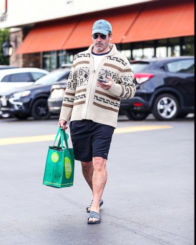 EXCLUSIVE: Jon Hamm Looked Cozingly Native In A Funky Sweater As He Grocery Shopped At Gelsons In Hollywood, CA. The Top Gun Star Was Seen Browsing The Aisles In Aviators and Flip Flops While Filling Up His Basket. 06 Jun 2022 Pictured: Jon Hamm. Photo credit: @CelebCandidly / MEGA TheMegaAgency.com +1 888 505 6342 (Mega Agency TagID: MEGA865788_028.jpg) [Photo via Mega Agency]