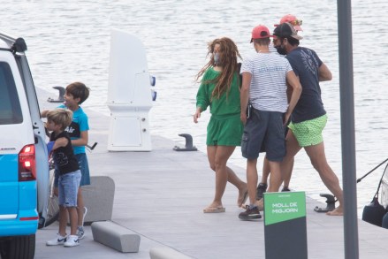 EXCLUSIVE: Shakira and her soccer star husband Gerard Pique are pictured on a yacht during their family vacation. The Colombian singer, 44, and the Barcelona defender, 34, set sail on a 45ft vessel with their sons Sasha and Milan. During the outing in Spain’s Costa Brava, the superstar singer kept covered up in a green sweater and shorts while footballer Pique stripped off his shirt. 28 Aug 2021 Pictured: Shakira, Gerard Pique. Photo credit: Emilio Utrabo / MEGA TheMegaAgency.com +1 888 505 6342 (Mega Agency TagID: MEGA782446_047.jpg) [Photo via Mega Agency]