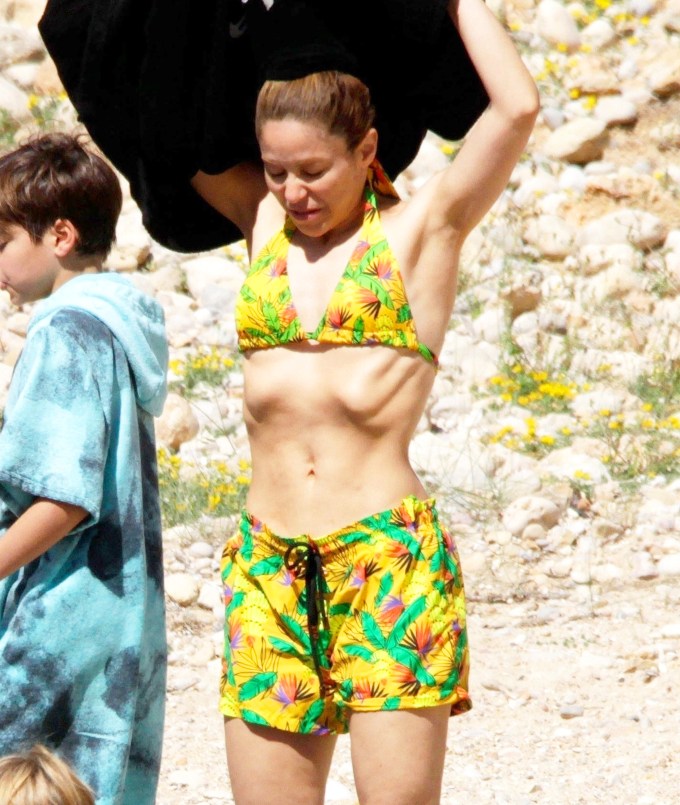 Shakira Sports A Matching Yellow Print Bikini & Shorts In Ibiza With Her Kids