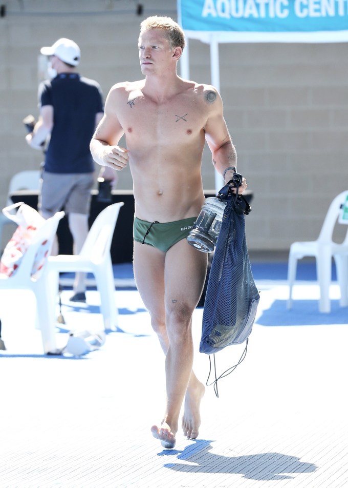 Cody Simpson walking poolside