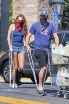 *EXCLUSIVE* Jon Hamm and injured Anna Osceola stock up before weekend