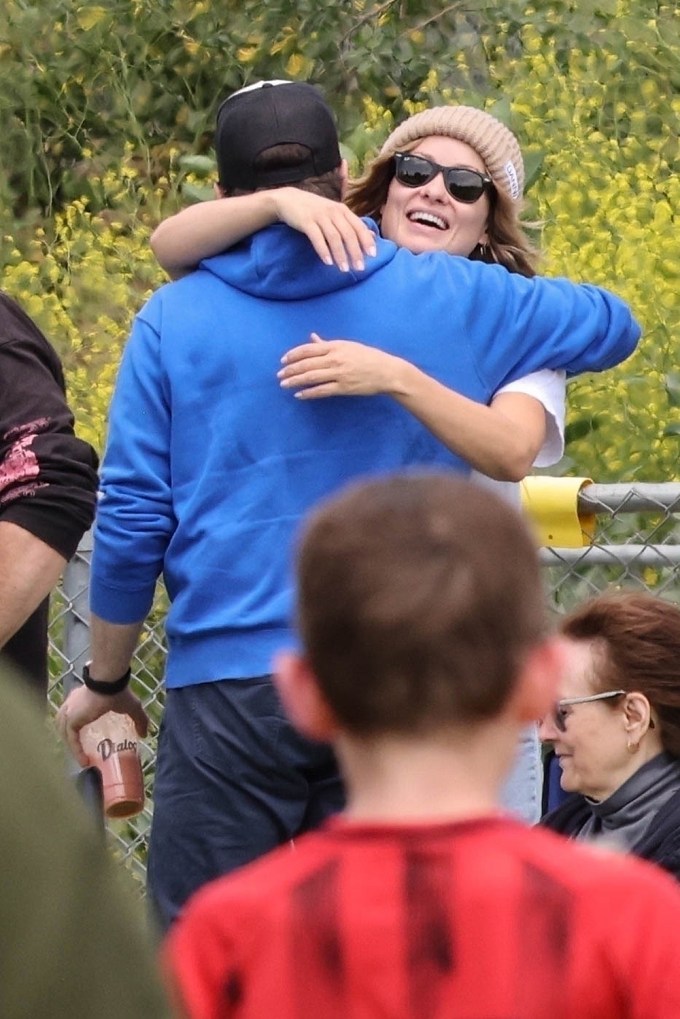 Jason Sudeikis and Olivia Wilde share a hug at their son’s soccer match