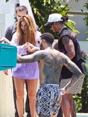 Shakira sparks new romance rumors as she enjoys a Miami boat trip with F1 ace Lewis Hamilton hours after the pair crossed paths at a fancy restaurant. The newly single and highly eligible bachelorette was picked up by the British-born racing star at the back of her own $20 million Miami Beach mansion on Wednesday. She was seen accepting Hamilton's offer of a hand, with the decorated Mercedes driver promptly got to his feet as she climbed aboard. They were accompanied on the cruise by heavily tattooed American fencer Miles Chamley-Watson, one of Hamilton's closest friends. It came the day after the two had crossed paths as Shakira made her way into Miami's upscale Cipriani restaurant, where Hamilton was dining out with pals on Tuesday evening. Speculation is now mounting around a potential new love match for the 46-year-old pop diva, who was also linked to Tom Cruise earlier this week amid reports the actor was "extremely interested" in pursuing her after they chatted at the Miami Grand Prix last weekend. But it seems she may be more interested in Hamilton, who competed in the flashy event. On Wednesday, she showed off her toned legs and torso in a flirty fringed lilac bikini top and matching shorts, wearing her famous long wavy hair loose over her shoulders. She was all smiles as she boarded the vessel which pulled up on Biscayne Bay behind her lavish waterfront pad. The 'Hips Don't Lie' songstress returned later on looking relaxed and went barefoot as she climbed back onto her personal dock. Shakira is newly single after splitting from soccer star Gerard Pique after 12 years. The former couple share two children, Sasha, 8, and Milan, 10. 10 May 2023 Pictured: Shakira and Lewis Hamilton. Photo credit: RM/MEGA TheMegaAgency.com +1 888 505 6342 (Mega Agency TagID: MEGA979957_001.jpg) [Photo via Mega Agency]