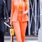 Blake Lively out in an eye-catching orange pants suit!