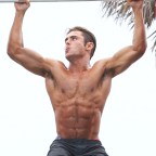 Zac Efron displaying his muscles doing pull ups in Miami Beach