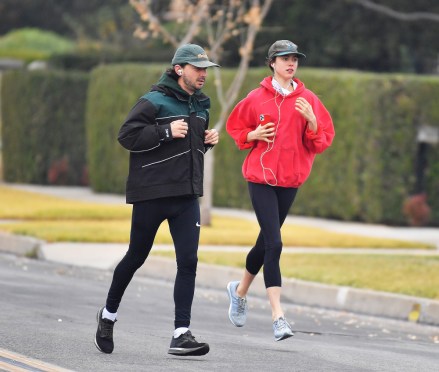 EXCLUSIVE: The couple that runs together! Shia LaBeouf and his girlfriend Margaret Qualley take early morning jog in his Pasadena neighborhood. The couple were seen taking a long jog in the early morning and kept their jackets on. 29 Dec 2020 Pictured: Shia LaBeouf and Margaret Qualley. Photo credit: Snorlax / MEGA TheMegaAgency.com +1 888 505 6342 (Mega Agency TagID: MEGA723471_019.jpg) [Photo via Mega Agency]