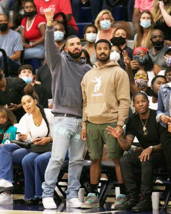 Chatsworth, CA - Drake & Michael B Jordan step out to support Bronny James, Amari Bailey & the Sierra Canyon Varsity Basketball squad play their last basketball game of the season.  Drake shows a lot of emotion during the game;  smiling, yelling frantically at the refs and cheering his boys as they fell short to be eliminated from the regional playoffs.  Interestingly enough Drake made his feeling known in the form of fashion as he donned jeans with 'Fuck You' printed near his crotch.  At the end of the game, he shows love to Amari Bailey who had a stellar season.  Pictured: Drake, Michael B. Jordan, Bronny James, Amari Bailey, Savannah James BACKGRID USA 17 JUNE 2021 BYLINE MUST READ: ShotbyNYP / BACKGRID USA: +1 310 798 9111 / usasales@backgrid.com UK: +44 208 344 2007 / uksales@backgrid.com *UK Clients - Pictures Containing Children Please Pixelate Face Prior To Publication*