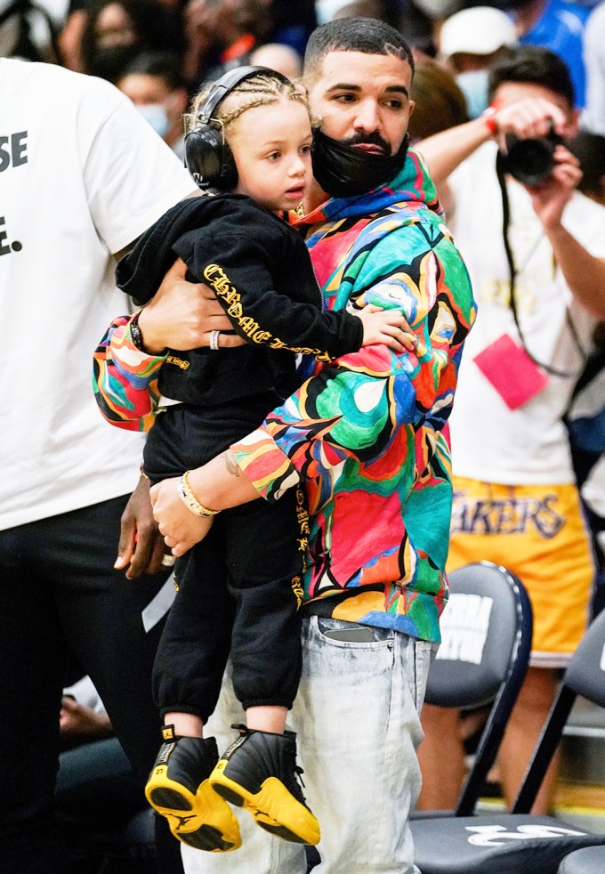 Drake and his son Adonis at a basketball game