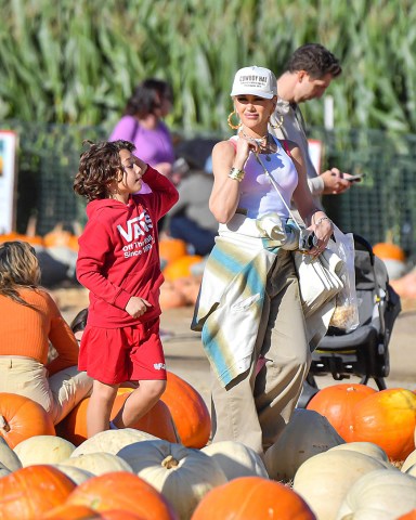 EXCLUSIVE: Gwen Stefani Took Her Boys Kingston, Zuma, & Apollo To The Pumpkin Patch At Underwood Farm In Moorpark, CA. The No Doubt Singer Stood Out In Her Fashionable Trademark OC Style As She Enjoyed The Harvest Festivities With Her Boys and Her Extended Family Including Her Parents, Her Two Brothers, And Their Kids. The Family Was Seen Enjoying Some Ice Cream And Tractor Trailer Rides. The 'I'm Just A Girl' Singer Was Also Seen Enjoying Herself As She Took Selfies And Wore Khaki Pants Along With Her Trademark Tank Top Under An Oversized Plaid Shirt and A Hat That Said 'Cowboy Hat'. Her Oldest Son Kingston Looked To Be Getting Older And Taller And Also Brought Along His Girlfriend. 23 Oct 2022 Pictured: Gwen Stefani Took Her Boys Kingston, Zuma, & Apollo To The Pumpkin Patch At Underwood Farm In Moorpark, CA. The No Doubt Singer Stood Out In Her Fashionable Trademark OC Style As She Enjoyed The Harvest Festivities With Her Boys and Her Extended Family Including Her Parents, Her Two Brothers, And Their Kids. The Family Was Seen Enjoying Some Ice Cream And Tractor Trailer Rides. The 'I'm Just A Girl' Singer Was Also Seen Enjoying Herself As She Took Selfies And Wore Khaki Pants Along With Her Trademark Tank Top Under An Oversized Plaid Shirt and A Hat That Said 'Cowboy Hat'. Her Oldest Son Kingston Looked To Be Getting Older And Taller And Also Brought Along His Girlfriend. Photo credit: @CelebCandidly / MEGA TheMegaAgency.com +1 888 505 6342 (Mega Agency TagID: MEGA910784_001.jpg) [Photo via Mega Agency]