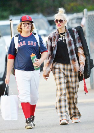 EXCLUSIVE: Gwen Stefani wears her flannel pajamas, a flannel shirt, and a t-shirt that reads Good Karma to Zuma's baseball game in LA on Thursday.  Blake Shelton did not attend the game.  Gwen was drinking coconut water throughout the game while talking to other parents in the stands.  26 May 2022 Pictured: Gwen Stefani wears flannel pajamas to Zuma's baseball game.  Photo credit: GP/ MEGA TheMegaAgency.com +1 888 505 6342 (Mega Agency TagID: MEGA862469_016.jpg) [Photo via Mega Agency]