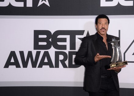 Lionel Richie poses in the press room with the lifetime achievement award at the BET Awards at the Nokia Theatre, in Los Angeles
2014 BET Awards - Press Room, Los Angeles, USA