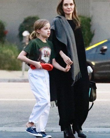 Los Angeles, CA  - Angelina Jolie and daughter Vivienne Marcheline pictured exiting a martial arts gym in L.A. this afternoon. The young red belt was chatting away while holding hands with her mom. Jolie wore a black maxi dress with a gray scarf over her shoulder and black leather booties.  Pictured: Angelina Jolie, Vivienne Marcheline Jolie-Pitt  BACKGRID USA 28 JANUARY 2019   USA: +1 310 798 9111 / usasales@backgrid.com  UK: +44 208 344 2007 / uksales@backgrid.com  *UK Clients - Pictures Containing Children Please Pixelate Face Prior To Publication*