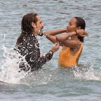 *EXCLUSIVE* Showing off her sexy little figure wearing her striking orange swimsuit, Zoe Saldana and husband Marco Perego enjoy a swim at Pevero beach during their family holiday in Sardinia