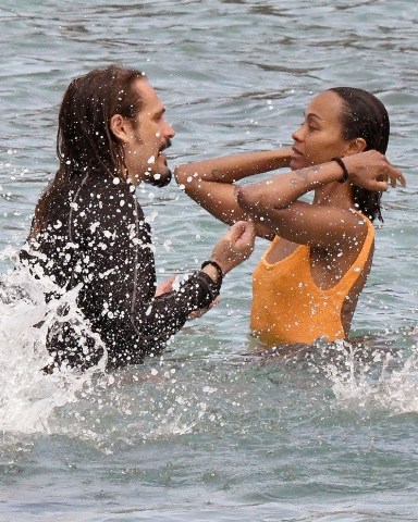 Sardinia, ITALY  - *EXCLUSIVE*  - Actress Zoe Saldana with her husband Marco Perego and their children, enjoy a swim in the Pevero beach in Sardinia, before getting back on their yacht and continuing the cruise in the beautiful Italian seas.  Zoe looked sexy showing off her figure wearing her striking orange swimsuit.  Pictured: Zoe Saldana  BACKGRID USA 23 JULY 2023   BYLINE MUST READ: FREZZA LA FATA - COBRA TEAM / BACKGRID  USA: +1 310 798 9111 / usasales@backgrid.com  UK: +44 208 344 2007 / uksales@backgrid.com  *UK Clients - Pictures Containing Children Please Pixelate Face Prior To Publication*