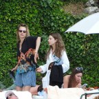 Cara Delevingne, wearing a t-shirt with Bob Marley's picture, seen kissing a new girlfriend singer Minke in the park of Hotel Splendido in Portofino