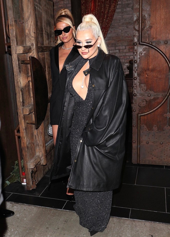 Christina Aguilera and Paris Hilton hold hands while leaving dinner at TAO