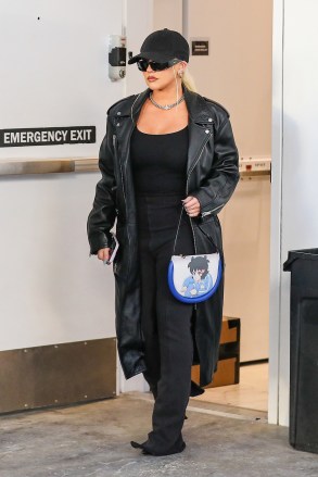 Beverly Hills, CA  - *EXCLUSIVE*  - Singer Christina Aguilera looks flawless in a trendy leather coat and flared black pants while shopping at Yves Saint Laurent on Rodeo drive. Christina accessorized her look with a blue anime graphic handbag.Pictured: Christina AguileraBACKGRID USA 10 NOVEMBER 2022 USA: +1 310 798 9111 / usasales@backgrid.comUK: +44 208 344 2007 / uksales@backgrid.com*UK Clients - Pictures Containing ChildrenPlease Pixelate Face Prior To Publication*