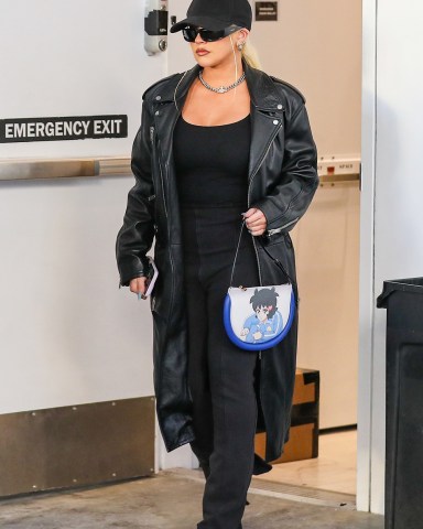 Beverly Hills, CA  - *EXCLUSIVE*  - Singer Christina Aguilera looks flawless in a trendy leather coat and flared black pants while shopping at Yves Saint Laurent on Rodeo drive. Christina accessorized her look with a blue anime graphic handbag.  Pictured: Christina Aguilera  BACKGRID USA 10 NOVEMBER 2022   USA: +1 310 798 9111 / usasales@backgrid.com  UK: +44 208 344 2007 / uksales@backgrid.com  *UK Clients - Pictures Containing Children Please Pixelate Face Prior To Publication*