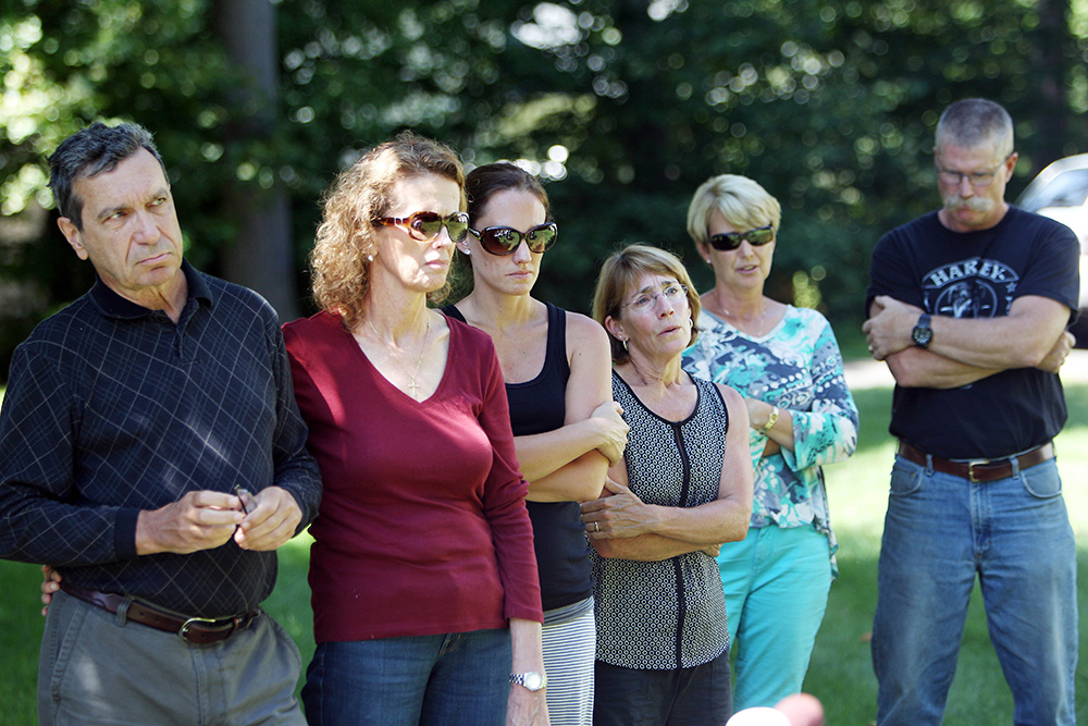 Family friends listen as Diane and John Foley talk to reporters, outside their home in Rochester, N.H., after speaking with President Obama. There son, James Foley was abducted in November 2012 while covering the Syrian conflict. Islamic militants posted a video showing his murder on Tuesday and said they killed him because the U.S. had launched airstrikes in northern Iraq
Journalist Slain, Rochester, USA