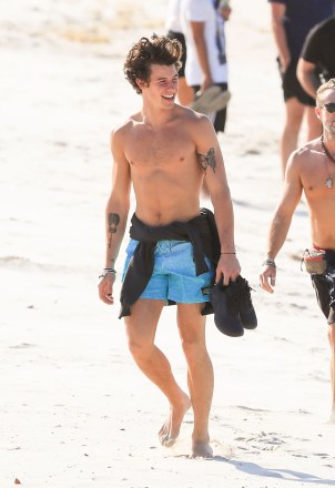 *NO MAIL ONLINE* Shawn Mendes takes in the sights of Byron Bay in Australia, enjoying a walk on the beach to Byron's famous lighthouse.Shawn took off his t-shirt to top up his tan during his afternoon walk, and stopped for selfies with some eager fans.Pictured: Shawn MendesRef: SPL5126534 051119 NON-EXCLUSIVEPicture by: Media-Mode / SplashNews.comSplash News and PicturesLos Angeles: 310-821-2666New York: 212-619-2666London: +44 (0)20 7644 7656Berlin: +49 175 3764 166photodesk@splashnews.comWorld Rights, No Australia Rights, No New Zealand Rights, No Spain Rights