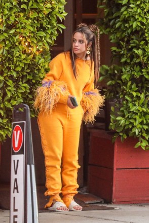 Santa Monica, CA  - *EXCLUSIVE*  - Camila Cabello wears a cozy orange sweats outfit with pom-pom-like sleeves and a few braids in her hair, as she and her mother Sinuhe are out for dinner in Santa Monica.Pictured: Camila Cabello BACKGRID USA 25 JUNE 2022 BYLINE MUST READ: BACKGRIDUSA: +1 310 798 9111 / usasales@backgrid.comUK: +44 208 344 2007 / uksales@backgrid.com*UK Clients - Pictures Containing ChildrenPlease Pixelate Face Prior To Publication*